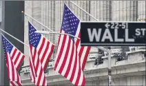  ?? FRANK FRANKLIN II – THE ASSOCIATED PRESS ?? American flags hang outside of the New York Stock Exchange, in February. Stocks set record highs on Thursday with an assist from technology companies, which have seen big swings in recent days.