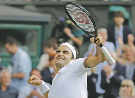  ?? BEN CURTIS/ASSOCIATED PRESS ?? Switzerlan­d’s Roger Federer celebrates defeating Spain’s Rafael Nadal on Friday at Wimbledon in London. Federer won in four sets and will face the other semifinal winner, Novak Djokovic, in Sunday’s final.