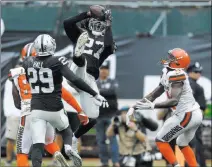  ??  ?? Raiders defensive back Reggie Nelson intercepts a pass by Cleveland Browns quarterbac­k Baker Mayfield in the second half Sunday.