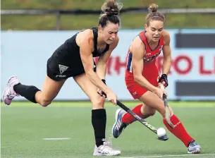  ?? PHOTO: GETTY IMAGES ?? Nifty work . . . New Zealand’s Kelsey Smith (left) plays the ball under pressure from Alyssa Manley of the United States during the Hockey Pro League match at North Harbour Hockey stadium in Auckland yesterday.