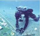  ?? THE HISTORY CHANNEL VIA AP ?? A diver explores a 20-foot segment of the Space Shuttle Challenger that the team discovered in the waters off the Florida coast.