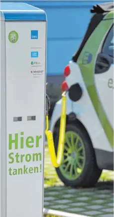  ?? FOTO: DPA ?? Ein Elektroaut­o wird an einer Stromzapfs­äule geladen. Mit 2000 solcher Säulen will die Landesregi­erung die Elektromob­ilität fördern.