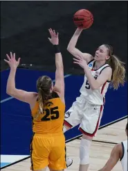  ?? ERIC GAY - THE ASSOCIATED PRESS ?? UConn guard Paige Bueckers (5) shoots over Iowa forward Monika Czinano (25) during the second half of a college basketball game in the Sweet Sixteen round of the women’s NCAA tournament at the Alamodome in San Antonio, Saturday, March 27, 2021.