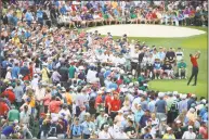  ?? Andrew Redington / Getty Images ?? Tiger Woods plays his shot from the third tee during the final round of the Masters on Sunday.