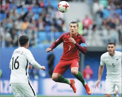  ??  ?? Portugal superstar Cristiano Ronaldo rises for a header during his team’s 4-0 Confederat­ions Cup victory over New Zealand in Saint Petersburg, Russia on Saturday. Ronaldo netted a 33rd-minute penalty for his 75th internatio­nal goal.