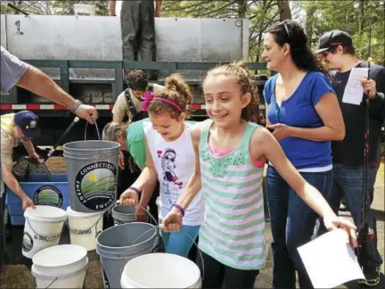  ?? FILE PHOTO ?? Children wait in line for their chance to take part in the most exciting event during free family fishing day in 2014 at Chatfield Hollow State Park in Killingwor­th.