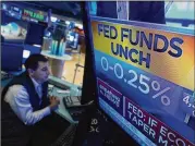  ?? RICHARD DREW/AP ?? A TV at the New York Stock Exchange shows the Fed’s rate decision Wednesday. It signaled it may start raising its benchmark interest rate sometime next year, a sign it’s concerned inflation pressures may persist.