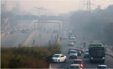  ??  ?? Vehicles travel along a road shrouded in smog in Delh. Toxic air is estimated to kill more than one million Indians each year, according to the non-profit Health Effects Institute.