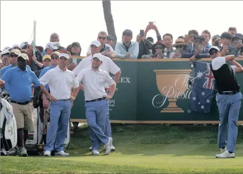  ?? PICTURE: AP ?? ALL T HE PRESIDENTS MAN: Internatio­nal team player Adam Scott hits his drive on the11th hole as teammates, from left, Marc Leishman, Branden Grace and Louis Oosthuizen, watch during a practice round ahead of the Presidents Cup beginning today at Jack...