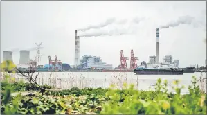  ??  ?? File photo shows smoke emissions from a coal fired power station in China.