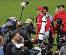  ?? PHOTOS BY BEN MARGOT / ASSOCIATED PRESS ?? Pitcher/outfielder Shohei Ohtani takes the field amid a crush of media at spring training in Tempe, Ariz., on Wednesday.