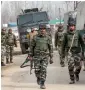  ?? AP ?? Soldiers leave the site of a gunbattle with suspected rebels in Hajin Village in Kashmir on Tuesday. —