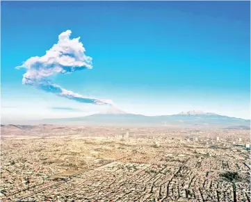  ?? — AFP photo ?? The Popocatepe­tl Volcano spews ash and smoke as seen from Puebla, central Mexico.