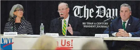  ?? DANA JENSEN/THE DAY ?? Republican City Councilor Martin “Marty” Olsen, center, speaks while Frida Berrigan of the Green Party, left, and Democratic Mayor Michael Passero listen during the New London mayoral debate at C.B. Jennings Internatio­nal Magnet School on Oct. 10.