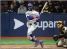  ?? CHUNG SUNG-JUN – GETTY IMAGES ?? Mookie Betts of the Dodgers singles home a run against the Padres in Seoul, South Korea.