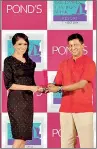  ??  ?? Siddharth Banerjee, Country Marketing Director of Unilever, Sri Lanka handing over a trophy to Danielle Kerkoven, winner of POND'S Face of Colombo Fashion Week - Resort Wear, 2014