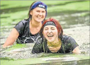  ?? ?? Runners swimming at Dirty Rotten Scramble’s Great Southern Mud Run