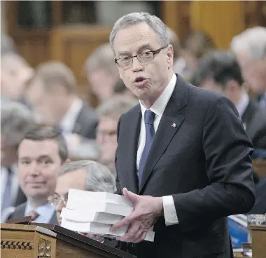  ?? ADRIAN WYLD/The Canadian Press ?? Finance Minister Joe Oliver tables the federal budget in the House of Commons on Tuesday.