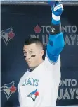  ?? DARREN CALABRESE / THE CANADIAN PRESS ?? Troy Tulowitzki tips his helmet after hitting a home run in the third inning against the Philadelph­ia Phillies Wednesday.