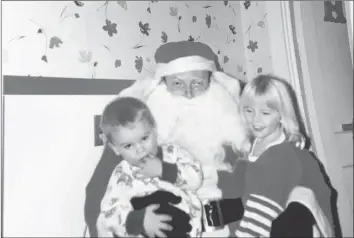  ??  ?? Lexie Misner, right, awaited the visit from Santa Claus every Christmas Eve.