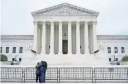  ?? [PATRICK SEMANSKY/ THE ASSOCIATED PRESS] ?? A woman and man pray Tuesday outside the Supreme Court on Capitol Hill in Washington, the day after the Senate confirmed Amy Coney Barrett to become a Supreme Court justice.