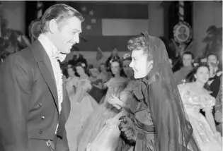  ?? AP PHOTO ?? Clark Gable, left, as Rhett Butler and Vivien Leigh as Scarlett O”Hara act in a scene from the film version of “Gone With the Wind” in 1939.