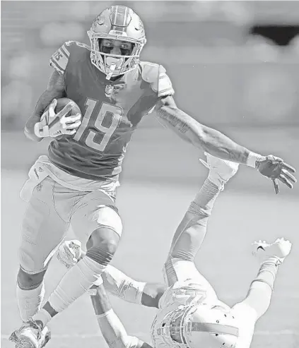  ?? JOHN MCCALL/SUN SENTINEL ?? Detroit Lions wide receiver Kenny Golladay gains yardage after shaking off Miami Dolphins safety T.J. McDonald in the second half Sunday.