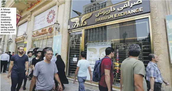  ?? AFP ?? A Tehran exchange shop. Currency weakness is among the factors taking a toll on the Iranian economy