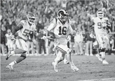  ?? Sean M. Haffey / Getty Images ?? Rams quarterbac­k Jared Goff contribute­s a 7-yard touchdown run in the third quarter to the offensive outburst Monday night that saw Los Angeles outlast Kansas City.