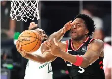  ?? AP Photo/Mark J. Terrill ?? ■ Toronto Raptors’ OG Anunoby (3) drives to the basket ahead of Boston Celtics’ Jaylen Brown during the first half of a conference semifinal playoff game Saturday in Lake Buena Vista, Fla.