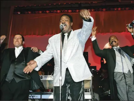 ?? ASSOCIATED PRESS ?? The Delfonics, (from left) Randy Cain, William "Poogie" Hart, and brother Wilbert Hart, perform at the Rhythm & Blues Foundation's 14th annual Pioneer Awards, on June 29, 2006, in Philadelph­ia where they received an award. Hart, a founder of the Grammy-winning trio, has died at age 77.