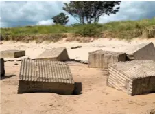  ??  ?? Ridged concrete blocks protrude from the beach at Alnmouth (above). The pillbox guard post (below).