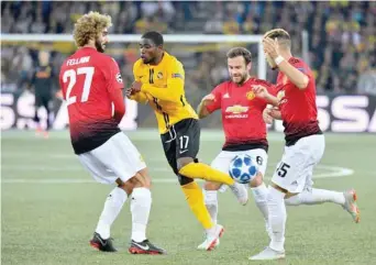  ?? — AFP ?? Manchester United’s Marouane Fellaini (left), Juan Mata (second right) and Andreas Pereira (right) fight for the ball with Young Boys Ivorian Roger Assalé (centre) during the UEFA Champions League group H match.