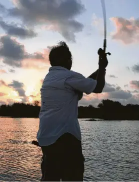  ?? Shannon Tompkins / Staff ?? Fishing at night from lighted piers, docks and boats rigged with generator-powered lighting can produce excellent results for coastal anglers looking to avoid the withering heat and often poor fishing common on late-summer days.