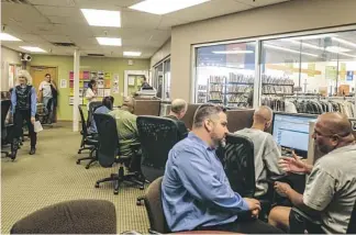  ?? ANGELA PIAZZA/THE REPUBLIC ?? Career-center educator Michael Lee speaks with job seeker Wes Davis on Wednesday at the Goodwill center. On any given day, about 420 people visit the career center for assistance.