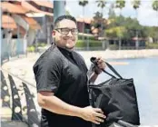  ?? STEPHEN M. DOWELL/ORLANDO SENTINEL ?? Chef Francisco (Frankie) Cortes is pictured with his food delivery bag at Disney Springs on Friday. He is among several local chefs delivering food to players and staff at Disney locations inside the NBA bubble.