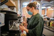  ?? AP ?? Waiter Sara Palacios prepares a coffee as she works at La Francachel­a restaurant in Madrid, Spain.