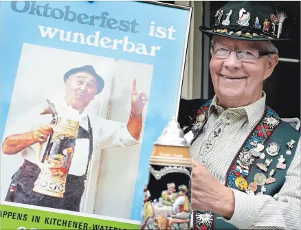 ?? ROD FRKETICH WATERLOO REGION RECORD ?? Owen Lackenbaue­r, one of the founders of Kitchener-Waterloo Oktoberfes­t, shows the poster from the first Oktoberfes­t. The annual celebratio­n turns 50 this year.
