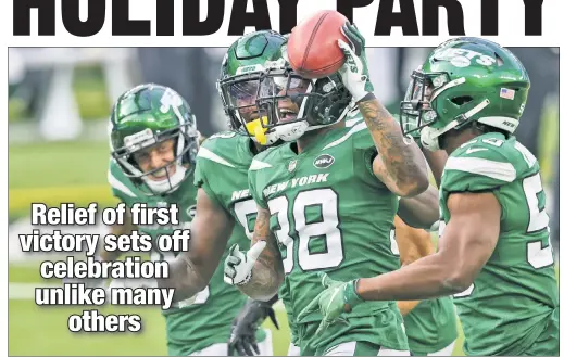  ?? EPA ?? HAVING A BALL: Rookie Lamar Jackson celebrates with some of his teammates after recovering a blocked punt in the Jets’ 23-20 win over the Rams on Sunday. The party continued in the postgame locker room and on the flight home.