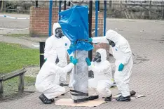  ??  ?? HOT SEAT: Above and right, the bench where Sergei Skripal and his daughter Yulia were found in critical condition, and army officers removing the bench for tests.