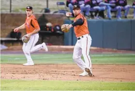  ?? KEVIN RICHARDSON/BALTIMORE SUN ?? Double-A Bowie Baysox third baseman Jordan Westburg, right, throws to first base during the season-opening game against the Richmond Flying Squirrels on Friday night at Prince George’s Stadium.