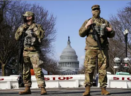  ?? Jacquelyn Martin/Associated Press ?? National Guard troops keep watch on the U.S. Capitol on Thursday in Washington. Capitol Police said they uncovered intelligen­ce of a “possible plot” by a militia group to breach the Capitol.