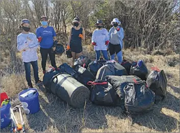  ??  ?? Volunteers collect over 40 bags of trash between 8 and 11 a.m. Sunday from the Maalaea ditch, which accumulate­s small and large debris throughout the dry season and discharges the garbage into the ocean during the rainy season.