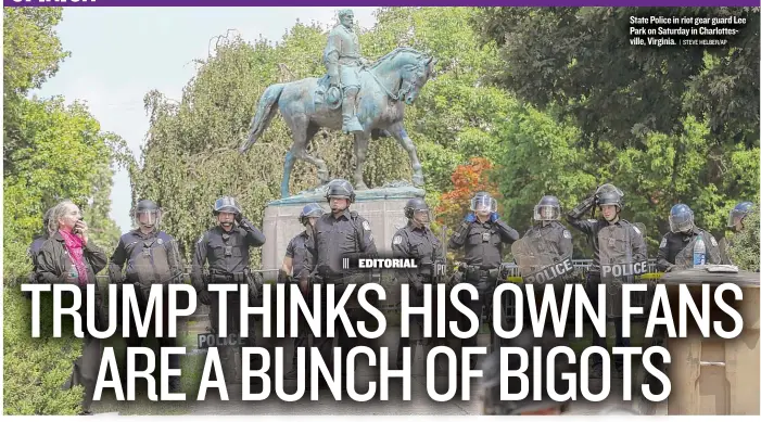  ?? | STEVE HELBER/ AP ?? State Police in riot gear guard Lee Park on Saturday in Charlottes­ville, Virginia.