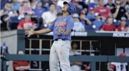  ?? NATI HARNIK/AP ?? UF’s Nelson Maldonado has battled through injuries during the Gators’ College World Series run.