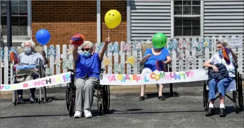  ?? Matt Freed/Post-Gazette ?? Residents wave to family members during a parade Friday at Norbert Personal Care Home in Overbrook.