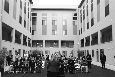  ?? ASSOCIATED PRESS PHOTOS ?? IN THIS DEC. 4, PHOTO, PHOENIX MAYOR KATE GALLEGO (FRONT LEFT) gets a hug from CEO of Native American Connection­s Diana Yazzie Devine (front right) during an open house ceremony at Native American Connection­s Urban Living on Fillmore affordable housing unit, in Phoenix. The just-opened 64-unit building has already reached full occupancy.