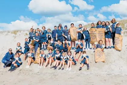  ?? ?? Students from Tahatai Coast School at the beach for their epic clean-up.