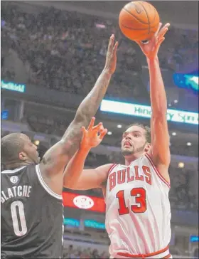  ?? | TOM CRUZE~SUN-TIMES ?? Bulls center Joakim Noah, who had 14 points, 15 rebounds, five assists and five blocks, shoots over Brooklyn’s Andray Blatche.