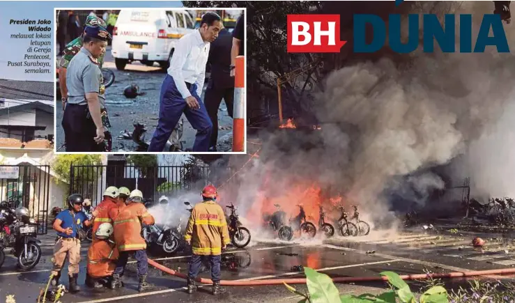  ??  ?? Anggota bomba bergegas memadamkan api yang membakar kenderaaan selepas letupan di sebuah gereja di Surabaya, semalam.